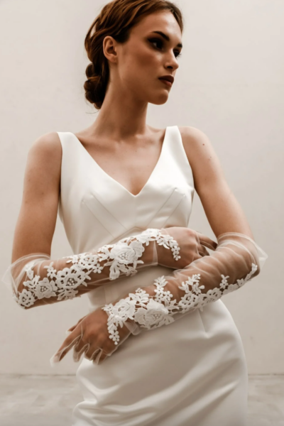 model wearing sheer opera length gloves with lace embellishments